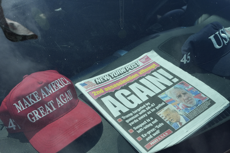 A newspaper is displayed in a vehicle outside of the Mar-a-Lago estate after the apparent assassination attempt of Republican presidential nominee and former President Donald Trump Monday, Sept. 16, 2024, in Palm Beach, Fla.