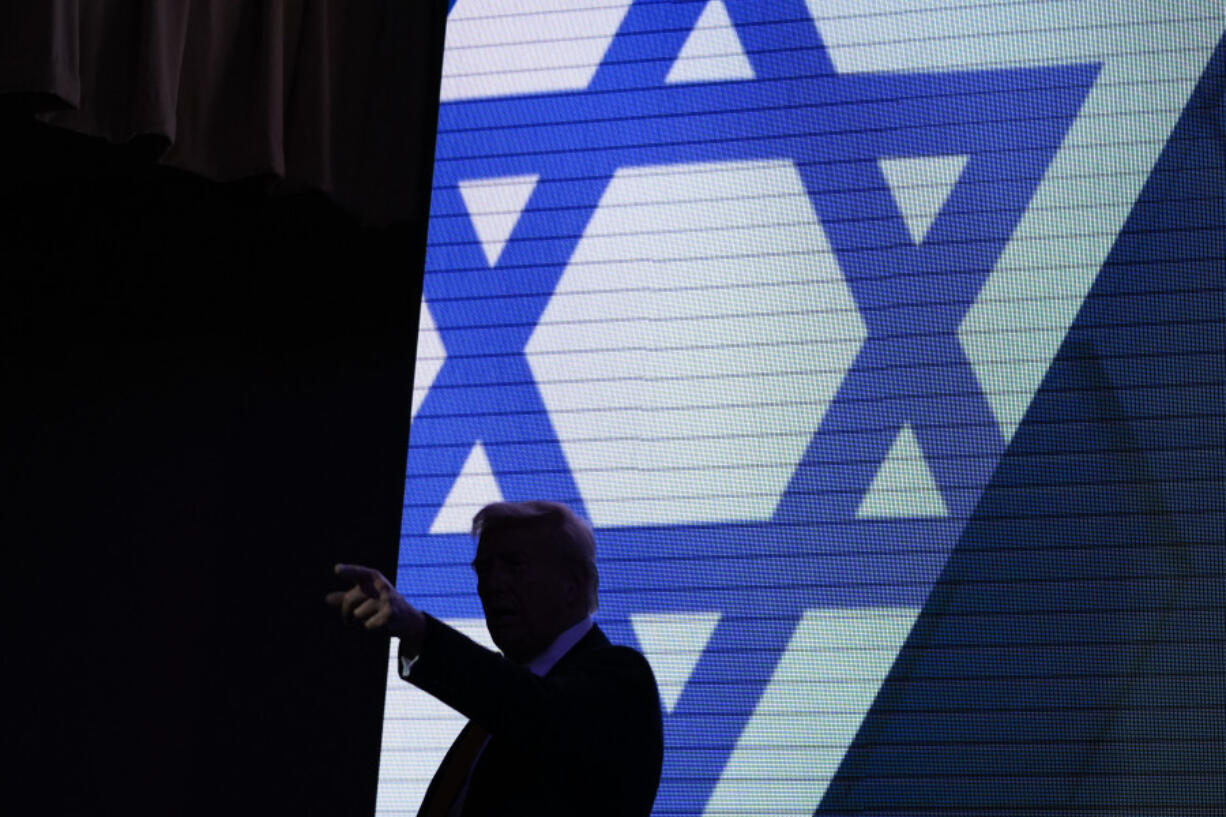 Republican presidential nominee former President Donald Trump acknowledges the crowd as he exits the stage after speaking at the Israeli American Council National Summit, Thursday, Sept. 19, 2024, in Washington.