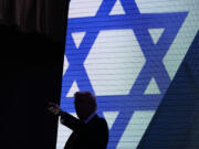 Republican presidential nominee former President Donald Trump acknowledges the crowd as he exits the stage after speaking at the Israeli American Council National Summit, Thursday, Sept. 19, 2024, in Washington.