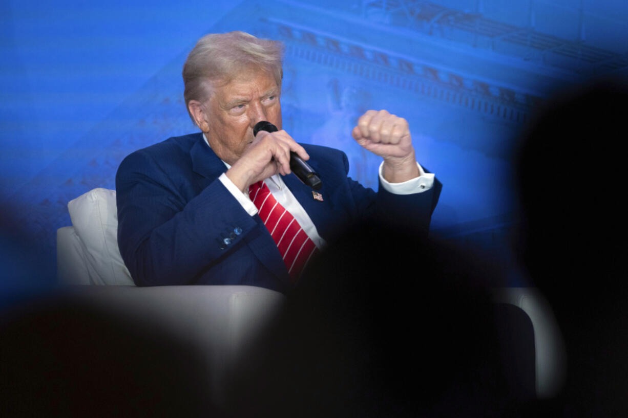 Republican presidential nominee former President Donald Trump speaks with Moms for Liberty co-founder Tiffany Justice during an event at the group&rsquo;s annual convention in Washington, Friday, Aug. 30, 2024.