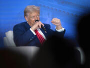 Republican presidential nominee former President Donald Trump speaks with Moms for Liberty co-founder Tiffany Justice during an event at the group&rsquo;s annual convention in Washington, Friday, Aug. 30, 2024.