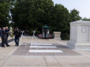 Bill Barnett, left, grandfather of Darin Taylor Hoover, and Republican presidential nominee former President Donald Trump place a wreath at the Tomb of the Unknown Solider in honor of Staff Sgt. Darin Taylor Hoover at Arlington National Cemetery, Monday, Aug. 26, 2024, in Arlington, Va.