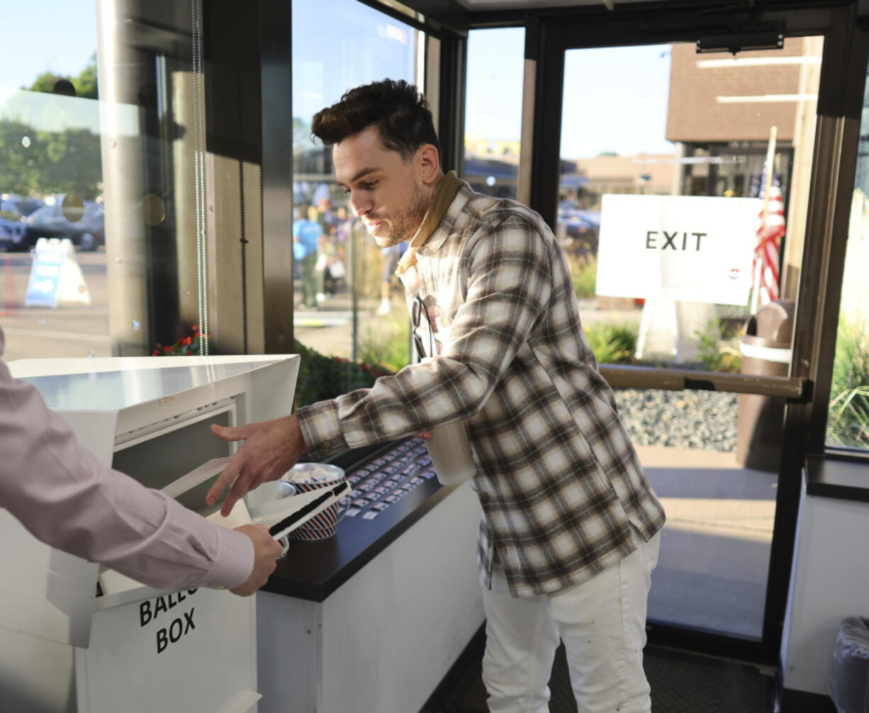 Minneapolis voter Jason Miller casts his ballot at the City of Minneapolis early voting center, Friday, September 20, 2024, in Minneapolis, Minn. Miller was the first resident in line to cast his vote.