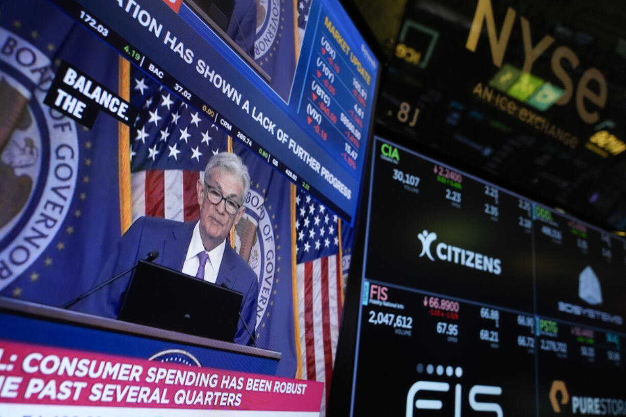 FILE - A screen displays a news conference with Federal Reserve Chairman Jerome Powell on the floor at the New York Stock Exchange in New York, May 1, 2024.