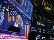 FILE - A screen displays a news conference with Federal Reserve Chairman Jerome Powell on the floor at the New York Stock Exchange in New York, May 1, 2024.