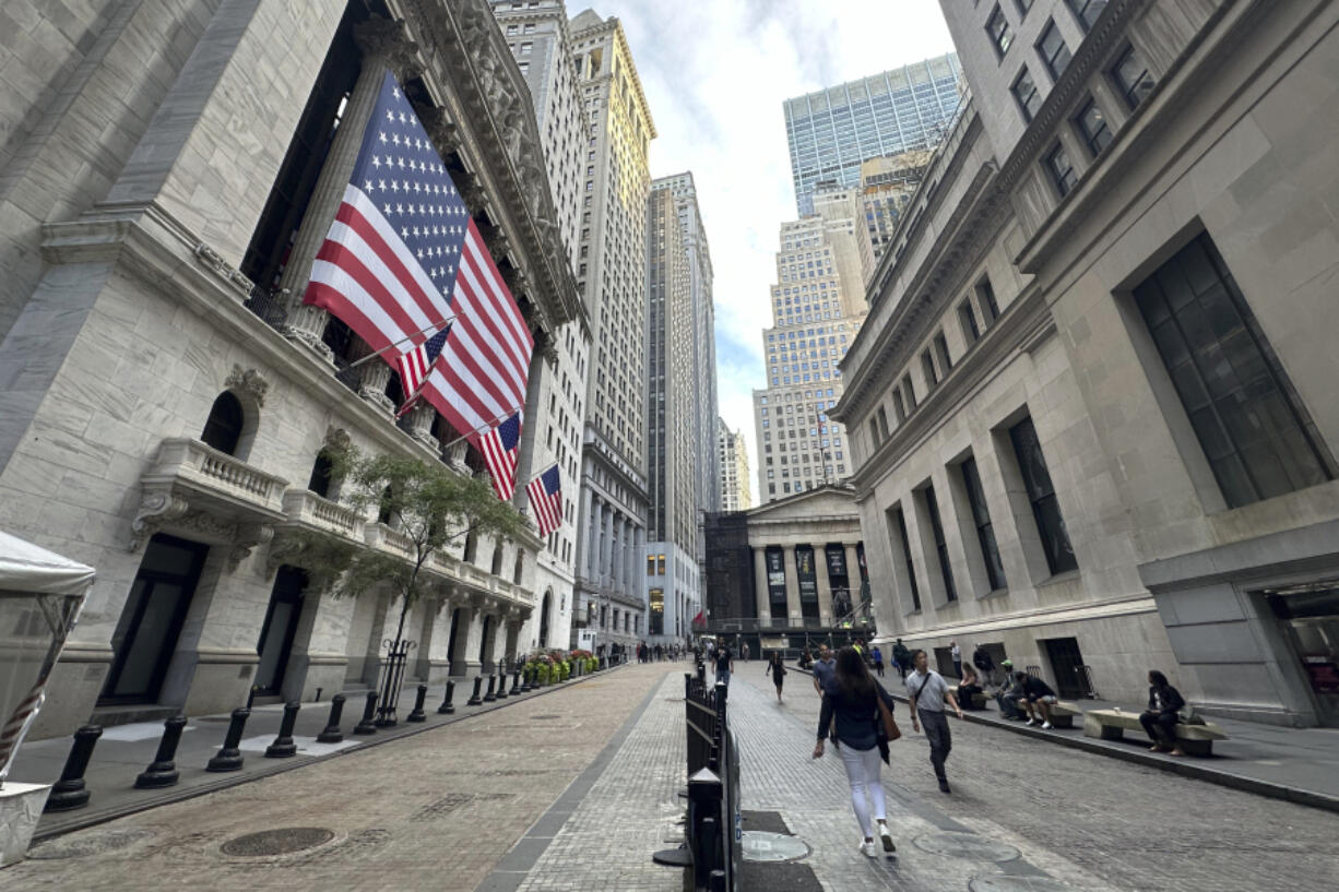 FILE - American flags hang from the front of the New York Stock Exchange on Sept. 11, 2024, in New York.