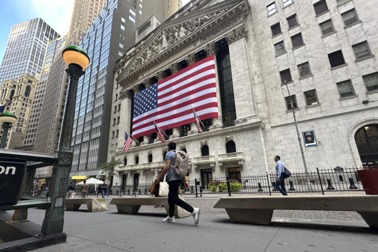 FILE - American flags hang on the front of the New York Stock Exchange on Sept. 11, 2024, in New York.