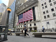 FILE - American flags hang on the front of the New York Stock Exchange on Sept. 11, 2024, in New York.