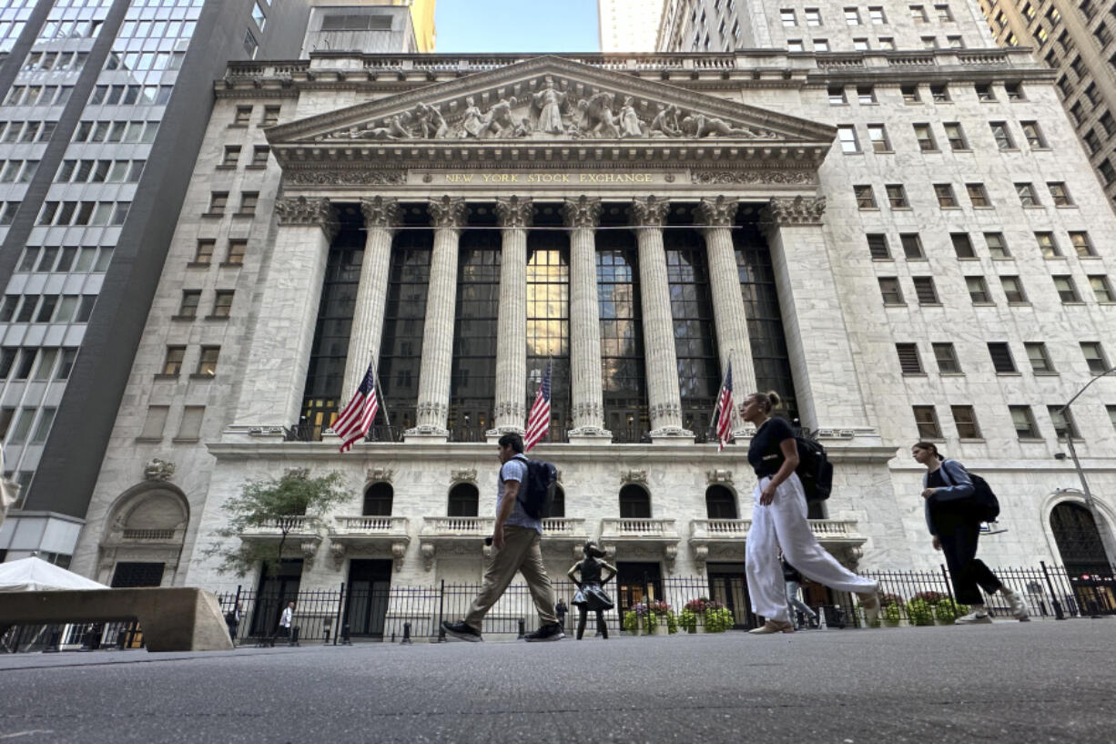 People pass the New York Stock Exchange on Wednesday, Sept. 4, 2024, in New York.