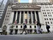 People pass the New York Stock Exchange on Wednesday, Sept. 4, 2024, in New York.