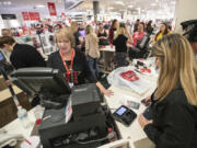 Terri Ross, left, checks out a customer at a store in the Huntington Mall in Barboursville, W.V.