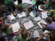 Children make signs as they attend a protest against Gov. Ron DeSantis&rsquo; plan to develop state parks with business ventures such as golf courses, pickleball courts and large hotels, during a demonstration at Oleta River State Park, Tuesday, Aug. 27, 2024, in North Miami Beach, Fla.