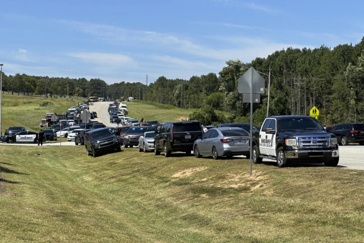 Law enforcement arrive as students are evacuated to the football stadium after the school campus was placed on lockdown at Apalachee High School in Winder, Ga., on Wednesday, Sept. 4, 2024.