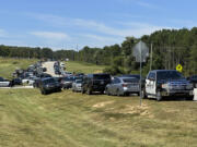 Law enforcement arrive as students are evacuated to the football stadium after the school campus was placed on lockdown at Apalachee High School in Winder, Ga., on Wednesday, Sept. 4, 2024.