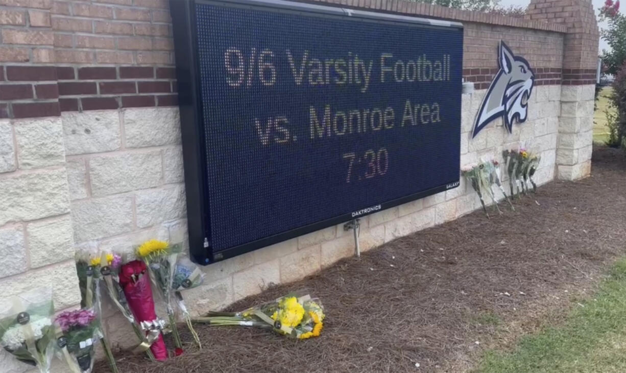 Flowers are placed outside the entrance to Apalachee High School on Thursday, Sept. 5, 2024 in Winder, Ga.,  a day after deadly shootings at the school.