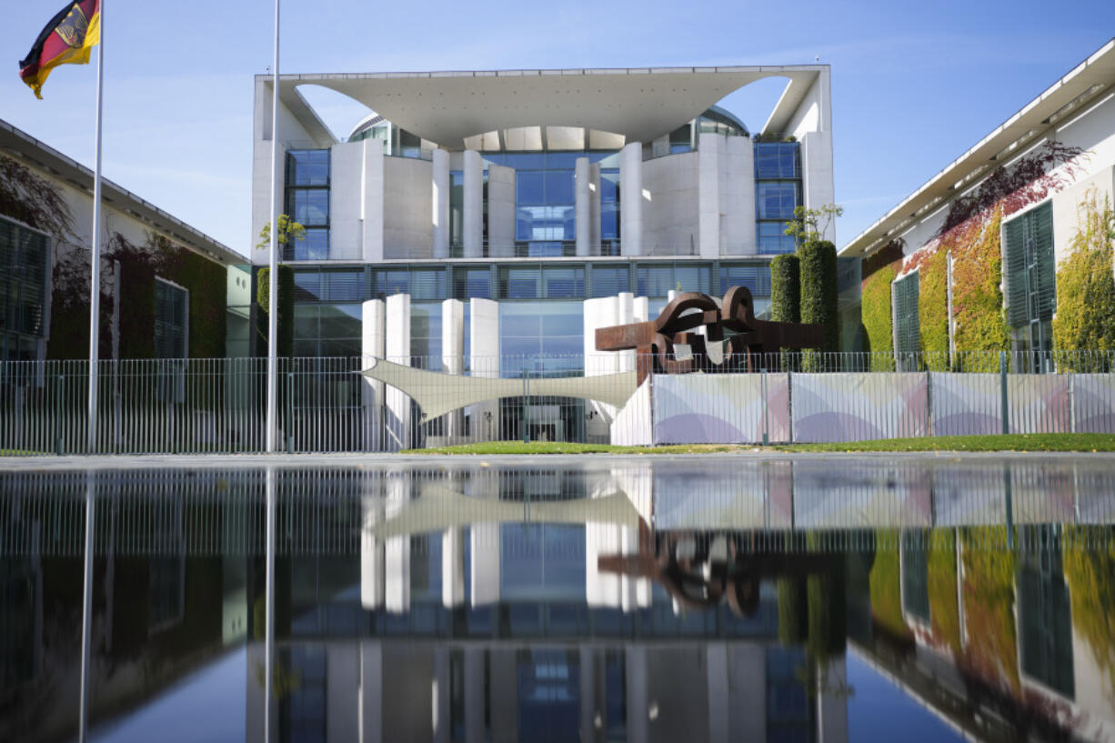 The Chancellery with the office of German Chancellor Olaf Scholz is reflected in a puddle in Berlin, Germany, Monday, Sept. 2, 2024.