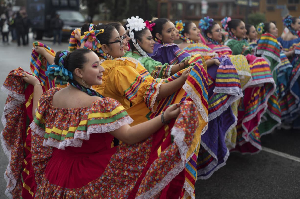 FILE - Members of the Cathedral City High School Ballet Folklorico pose for photo prior to joining in the Kingdom Day Parade in Los Angeles, Jan. 16, 2023.