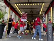 Hotel workers on strike chant and beat drums while picketing outside the Fairmont Copley Plaza hotel on Sunday in Boston.