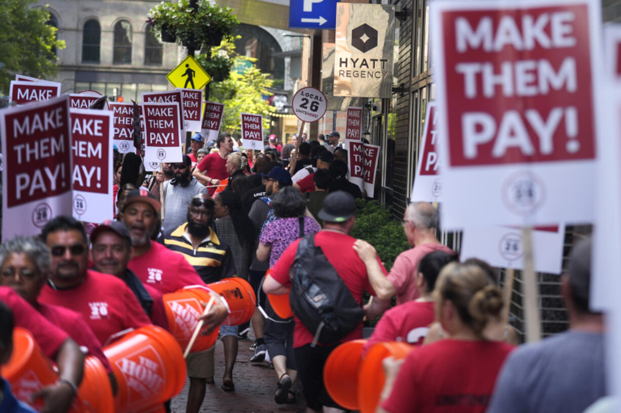 Union members from Local 26, representing workers in the hospitality industries of Massachusetts, picket outside the Hyatt Regency Boston, Wednesday, July 17, 2024, in Boston.