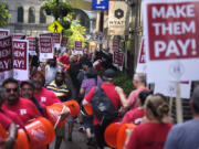 Union members from Local 26, representing workers in the hospitality industries of Massachusetts, picket outside the Hyatt Regency Boston, Wednesday, July 17, 2024, in Boston.