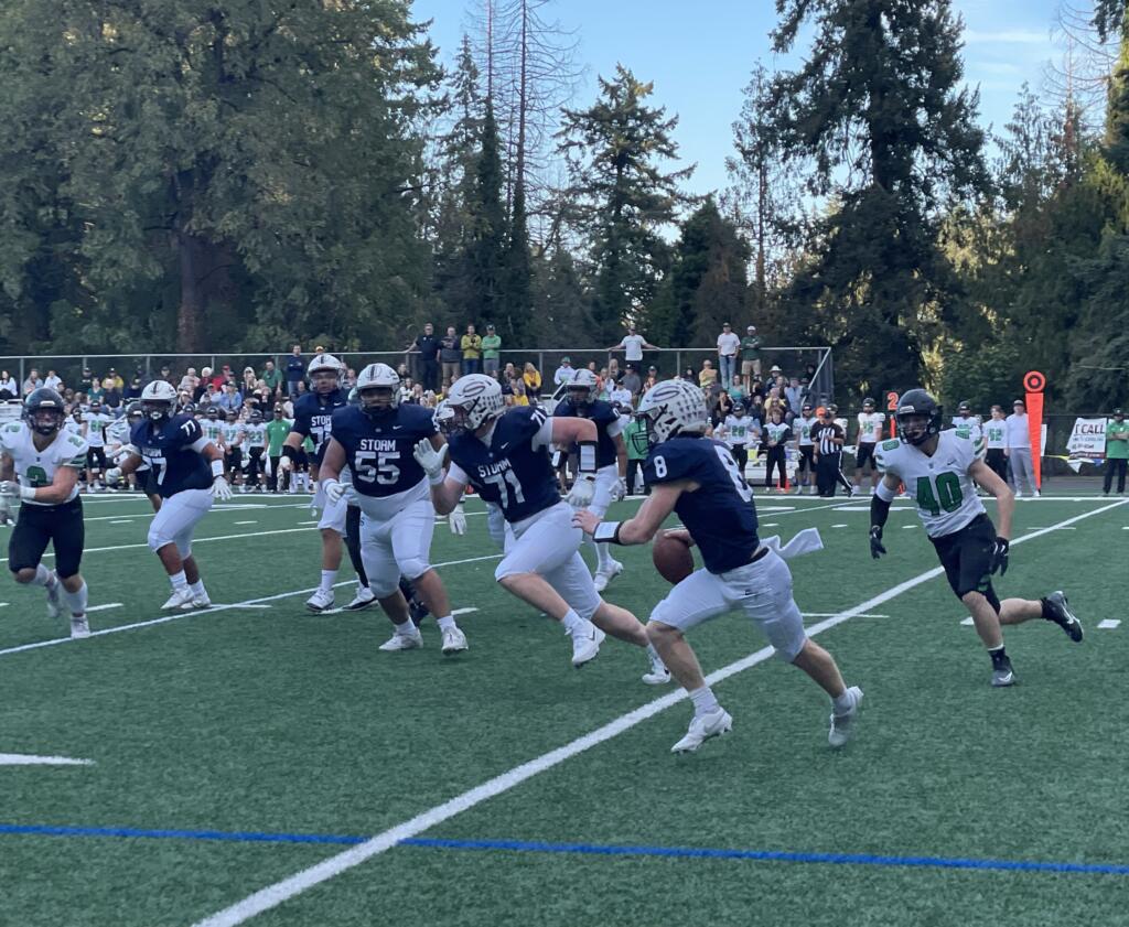 Skyview's Gavin Packer (8) looks to scramble against West Linn's James Johnstone (40) during a non-league football game on Friday, Sept. 27, 2024, at Kiggins Bowl.