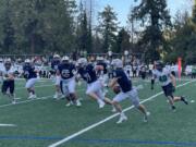 Skyview's Gavin Packer (8) looks to scramble against West Linn's James Johnstone (40) during a non-league football game on Friday, Sept. 27, 2024, at Kiggins Bowl.