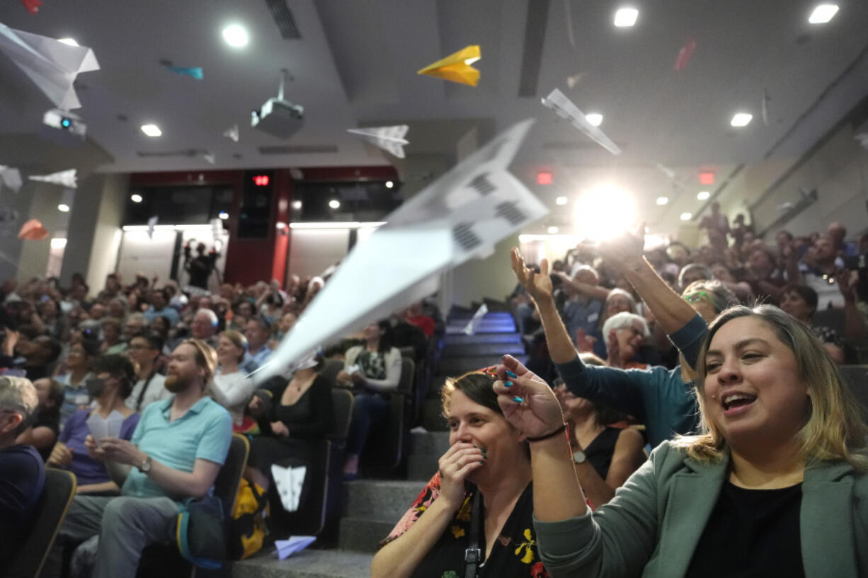 People in the audience throw paper airplanes toward the stage during a performance at the Ig Nobel Prize ceremony at Massachusetts Institute of Technology in Cambridge, Mass., Thursday, Sept. 12, 2024.