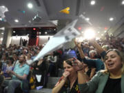 People in the audience throw paper airplanes toward the stage during a performance at the Ig Nobel Prize ceremony at Massachusetts Institute of Technology in Cambridge, Mass., Thursday, Sept. 12, 2024.