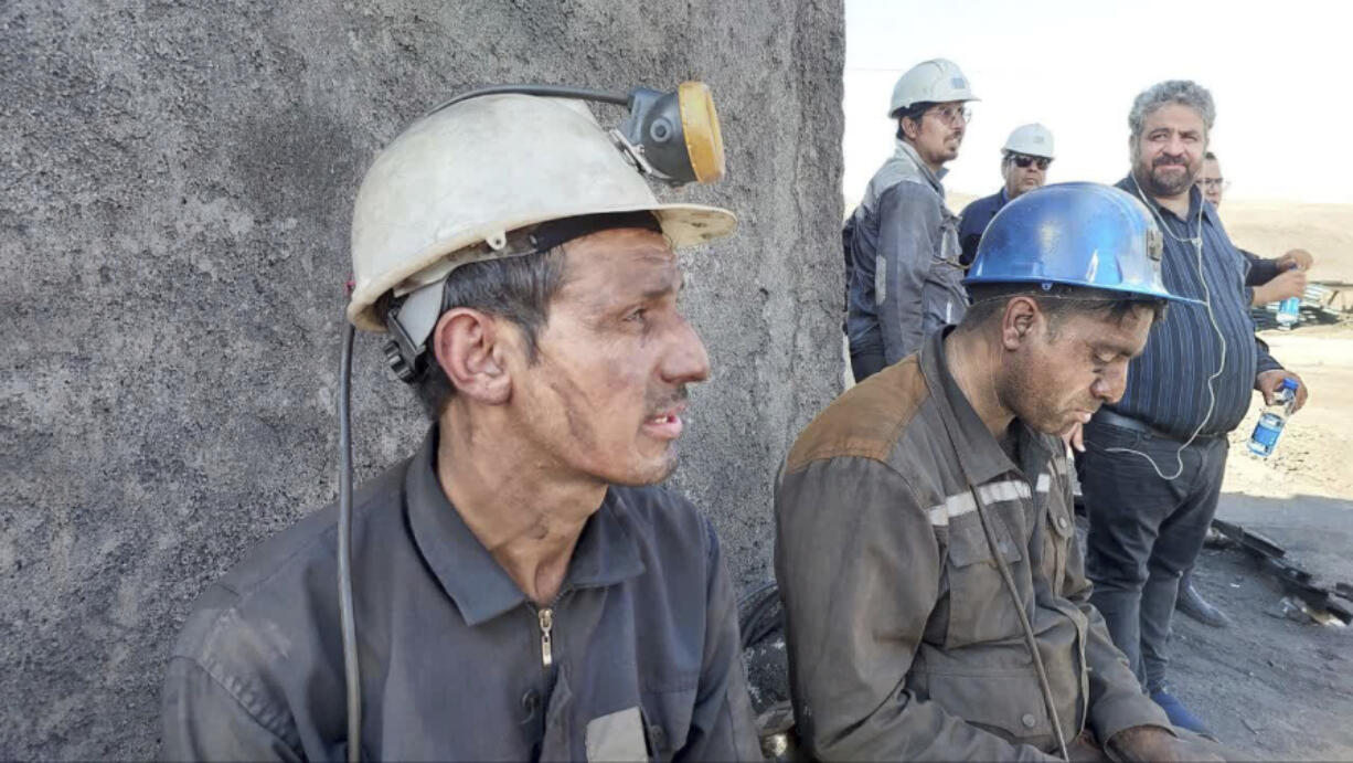 In this photo released on Tuesday, Sept. 24, 2024, by Iranian Interior Ministry, miners sit at the site of a coal mine where methane leak sparked an explosion on Saturday, in Tabas, some 335 miles (540 kilometers) southeast of the capital Tehran, Iran.