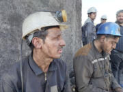 In this photo released on Tuesday, Sept. 24, 2024, by Iranian Interior Ministry, miners sit at the site of a coal mine where methane leak sparked an explosion on Saturday, in Tabas, some 335 miles (540 kilometers) southeast of the capital Tehran, Iran.