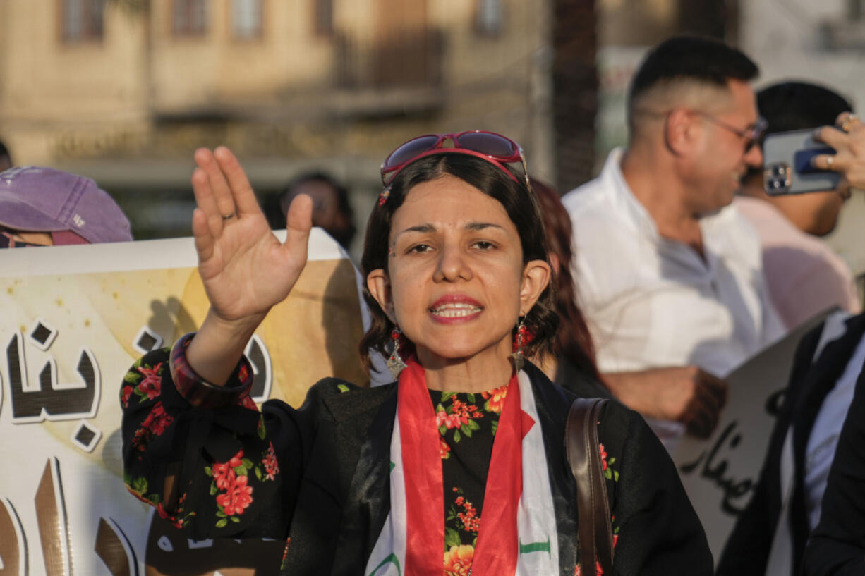 FILE- An Iraqi woman protests against a proposed law to permit underage female marriage in Tahrir Square in Baghdad, Iraq, July 28, 2024. Rights groups and many Iraqi women fear the country&rsquo;s parliament will open the door to child marriages as lawmakers consider legal changes that would give religious authorities more power over family law.