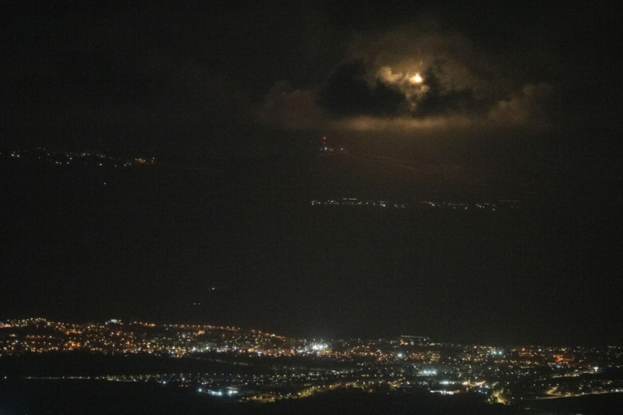 An Israeli army flare is seen over the Israeli-Lebanese border at the Galilee region as seen from the Israeli-annexed Golan Heights, Sunday, Sept. 15, 2024.