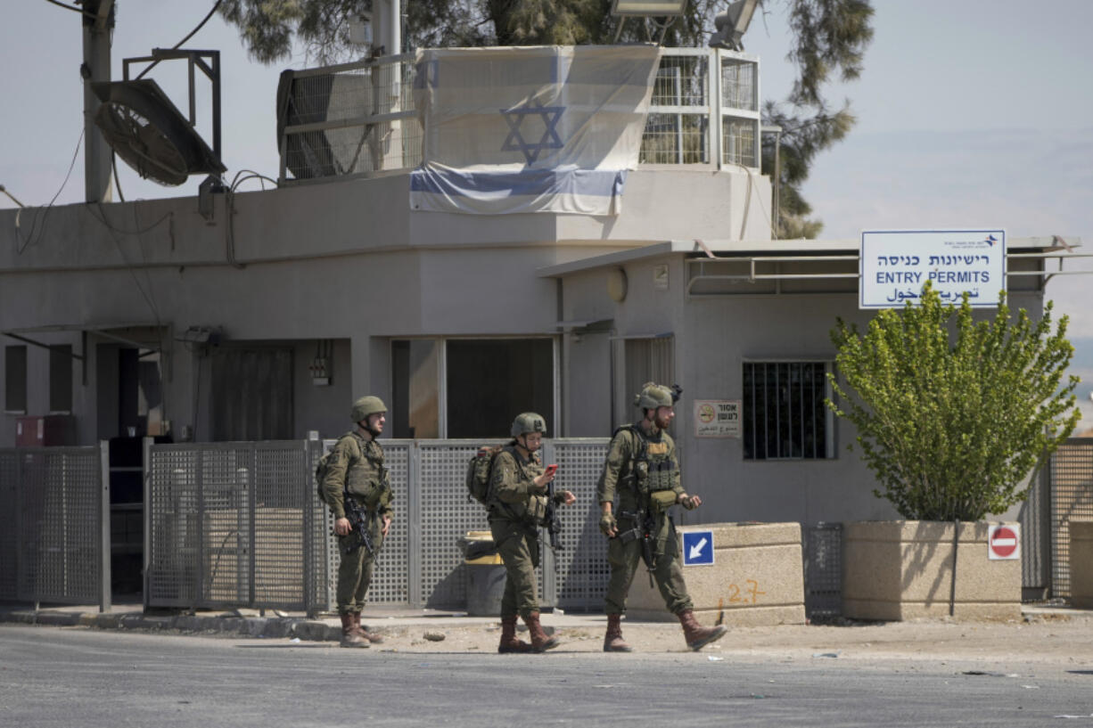 Israeli soldiers stand guard near the site of a deadly shooting attack where Israeli officials say three people were shot and killed at the Allenby Bridge Crossing between the West Bank and Jordan, Sunday, Sept. 8, 2024.