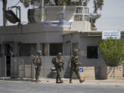 Israeli soldiers stand guard near the site of a deadly shooting attack where Israeli officials say three people were shot and killed at the Allenby Bridge Crossing between the West Bank and Jordan, Sunday, Sept. 8, 2024.