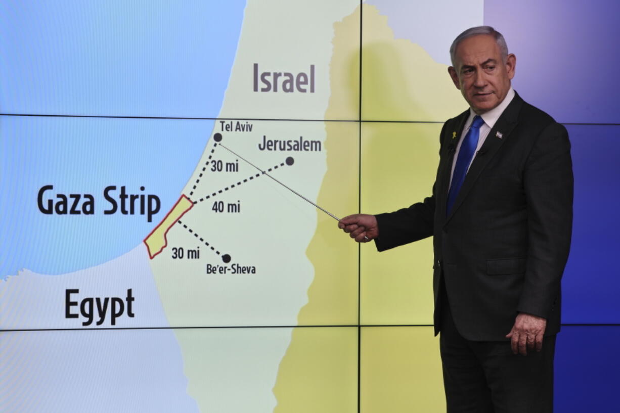 Israeli Prime Minister Benjamin Netanyahu gestures in front of a map during a press conference at the Government Press office in Jerusalem, Wednesday, Sept. 4, 2024.