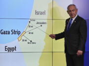 Israeli Prime Minister Benjamin Netanyahu gestures in front of a map during a press conference at the Government Press office in Jerusalem, Wednesday, Sept. 4, 2024.