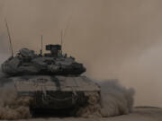 An Israeli tank manoeuvres near the Israel-Gaza border, southern Israel, Thursday, Aug. 29, 2024.