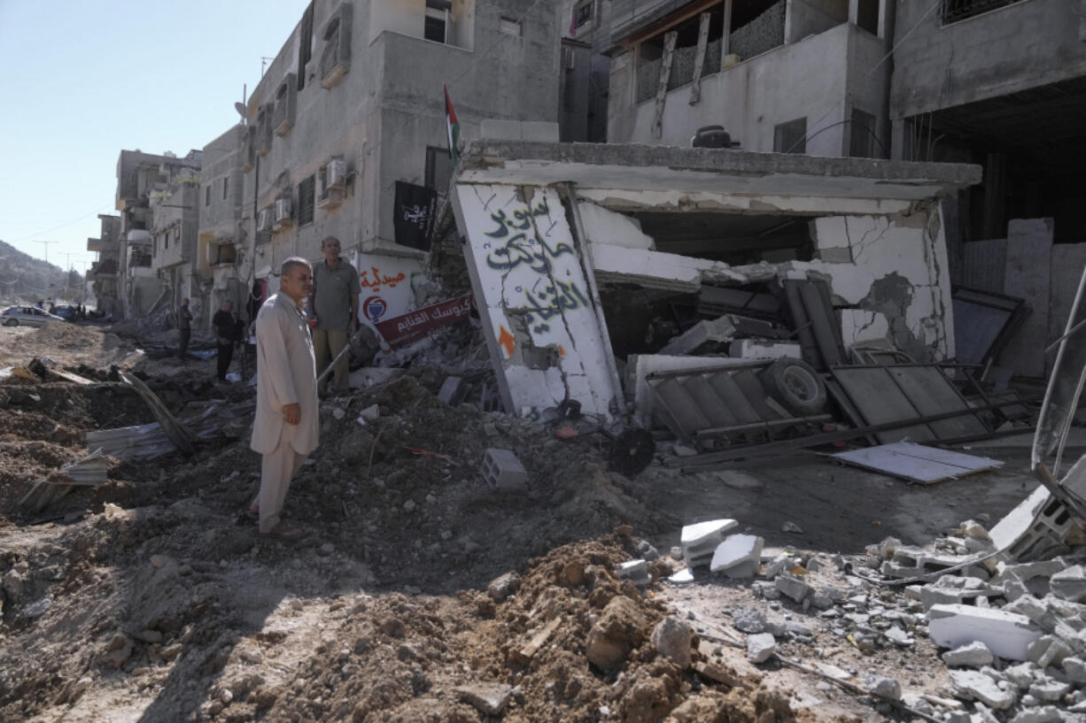 People inspect the destruction following an Israeli forces raid in Tulkarem, West Bank, on Wednesday, Sept. 11, 2024.