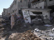 People inspect the destruction following an Israeli forces raid in Tulkarem, West Bank, on Wednesday, Sept. 11, 2024.