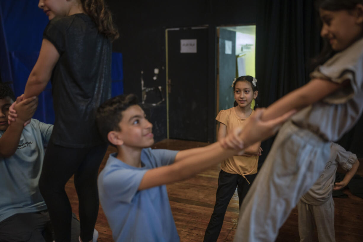 Children rehearse for a show in a theater in Jenin, West Bank, Saturday, June 8, 2024.