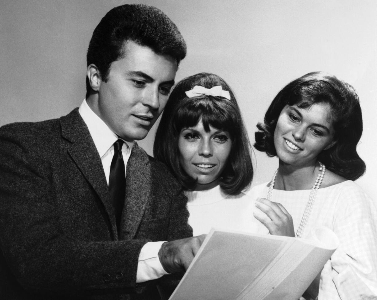 FILE - James Darren &mdash; left, one of the stars of the film For Those Who Think Young &mdash; chats with Nancy Sinatra, centre, and Claudia Martin about their film debuts, August 13, 1963.