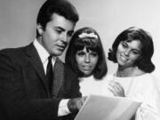 FILE - James Darren &mdash; left, one of the stars of the film For Those Who Think Young &mdash; chats with Nancy Sinatra, centre, and Claudia Martin about their film debuts, August 13, 1963.