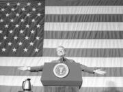 President Jimmy Carter acknowledges the applause of about 1,100 people gathered in the Elk City High School gym for a town meeting in Elk City, Okla., on March 24, 1979.