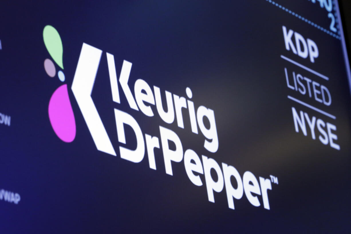 The new logo for Keurig Dr. Pepper appears above a trading post on the floor of the New York Stock Exchange, Thursday, July 12, 2018.