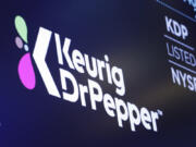 The new logo for Keurig Dr. Pepper appears above a trading post on the floor of the New York Stock Exchange, Thursday, July 12, 2018.