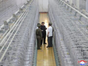 This undated photo provided on Friday, Sept. 13, 2024, by the North Korean government shows its leader Kim Jong Un, center, on an inspecting visit at what they say is an institute of nuclear weapons and a facility for nuclear materials at an undisclosed location in North Korea. Independent journalists were not given access to cover the event depicted in this image distributed by the North Korean government. The content of this image is as provided and cannot be independently verified. Korean language watermark on image as provided by source reads: &quot;KCNA&quot; which is the abbreviation for Korean Central News Agency.