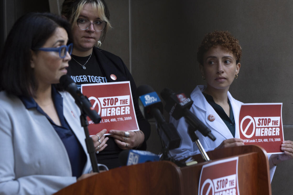 Kim Cordova, President UFCW 7, left, speaks about the Kroger and Albertsons merger during a news conference outside the federal courthouse before a hearing on the merger on Monday, Aug. 26, 2024, in Portland, Ore. Rickee Nelson, UFCW Local 7 member and grocery store worker, center, and Jessi Crowley, a pharmacist at Albertsons-owned Pavilions, right, listen.