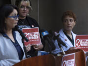 Kim Cordova, President UFCW 7, left, speaks about the Kroger and Albertsons merger during a news conference outside the federal courthouse before a hearing on the merger on Monday, Aug. 26, 2024, in Portland, Ore. Rickee Nelson, UFCW Local 7 member and grocery store worker, center, and Jessi Crowley, a pharmacist at Albertsons-owned Pavilions, right, listen.