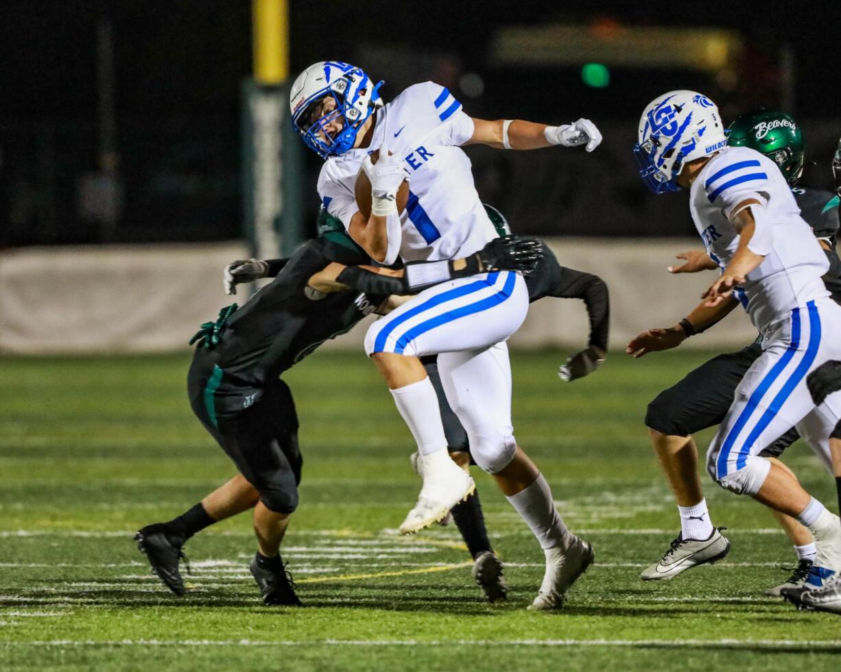 La Center's Houston Coyle returns a punt during a non-league football game against Woodland on Friday, Sept. 13, 2024 at Woodland High School.