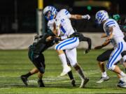 La Center's Houston Coyle returns a punt during a non-league football game against Woodland on Friday, Sept. 13, 2024 at Woodland High School.